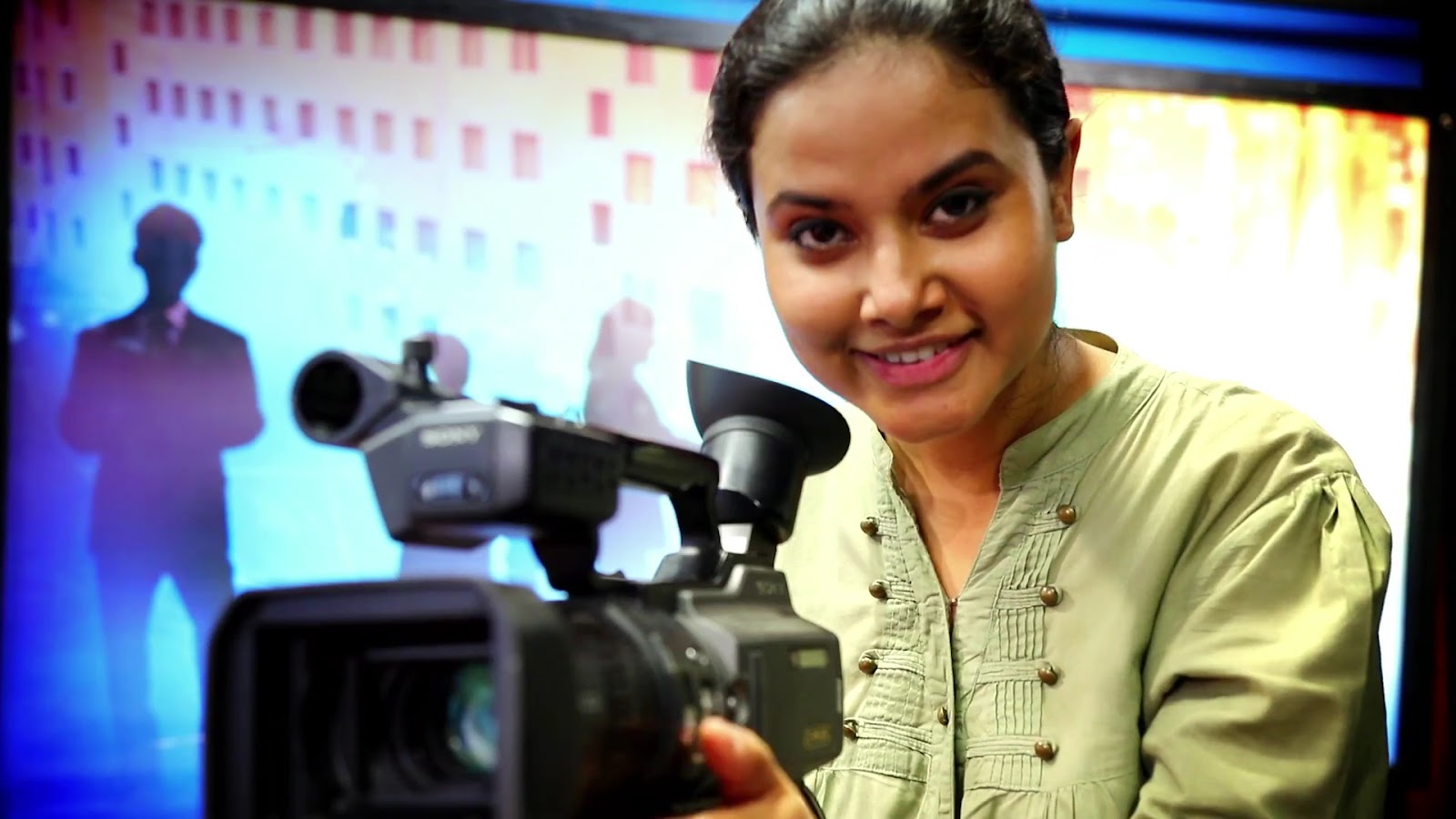 Student operating a professional camera in the campus media studio